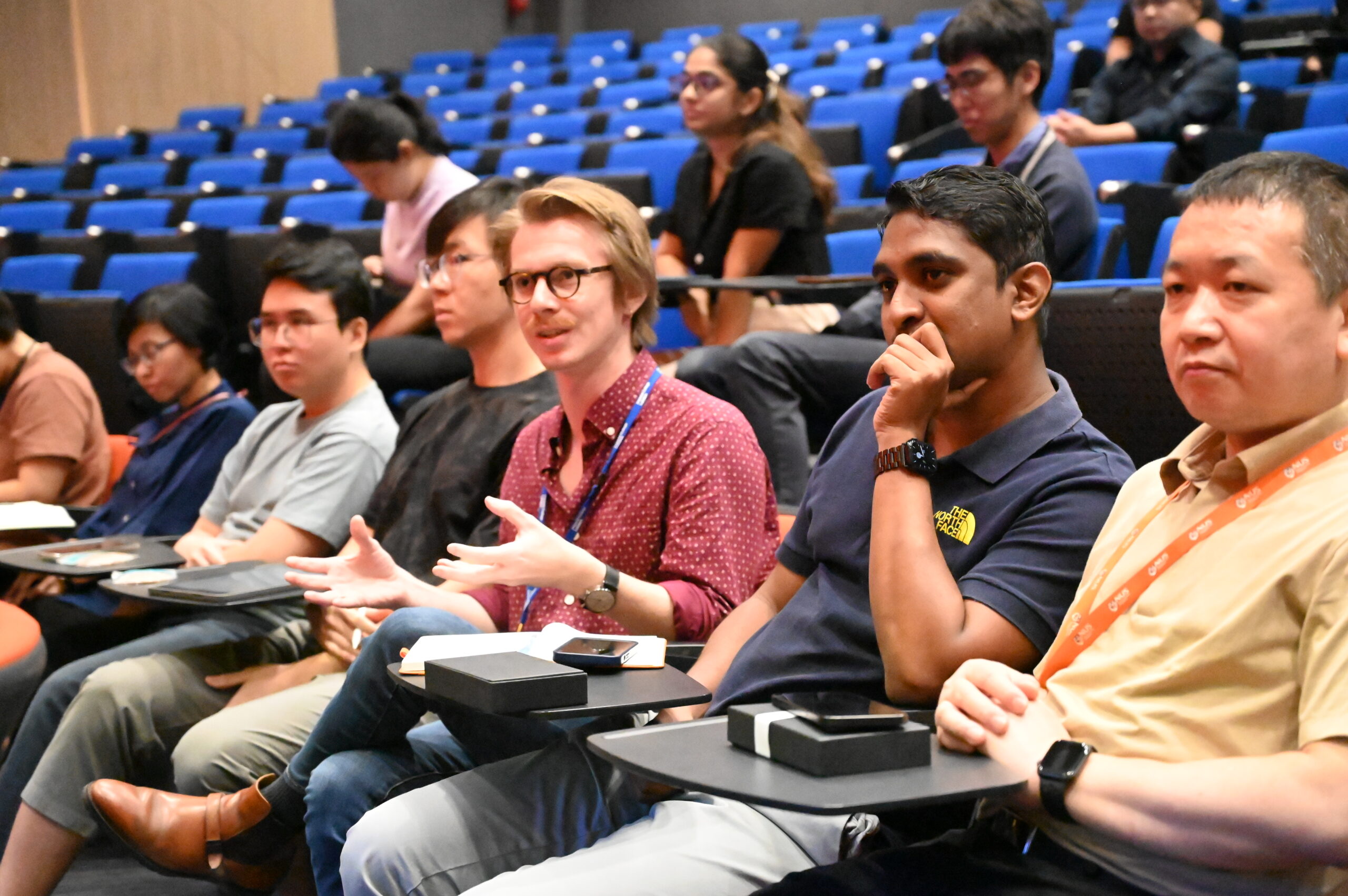 Attendees interacting at a talk by Dr. Satheesh